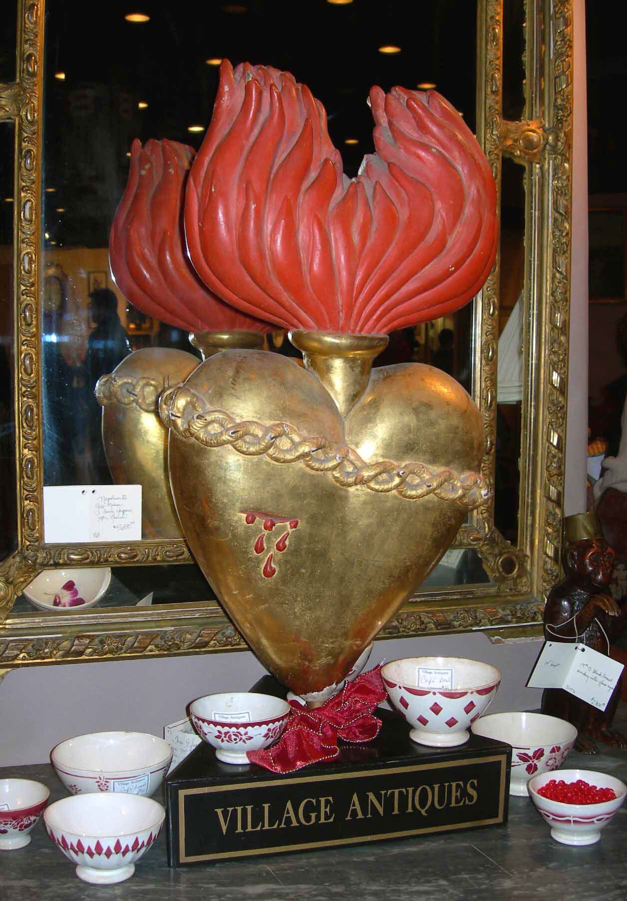 Gilded sacred-heart sculpture on the Village Antiques display plinth