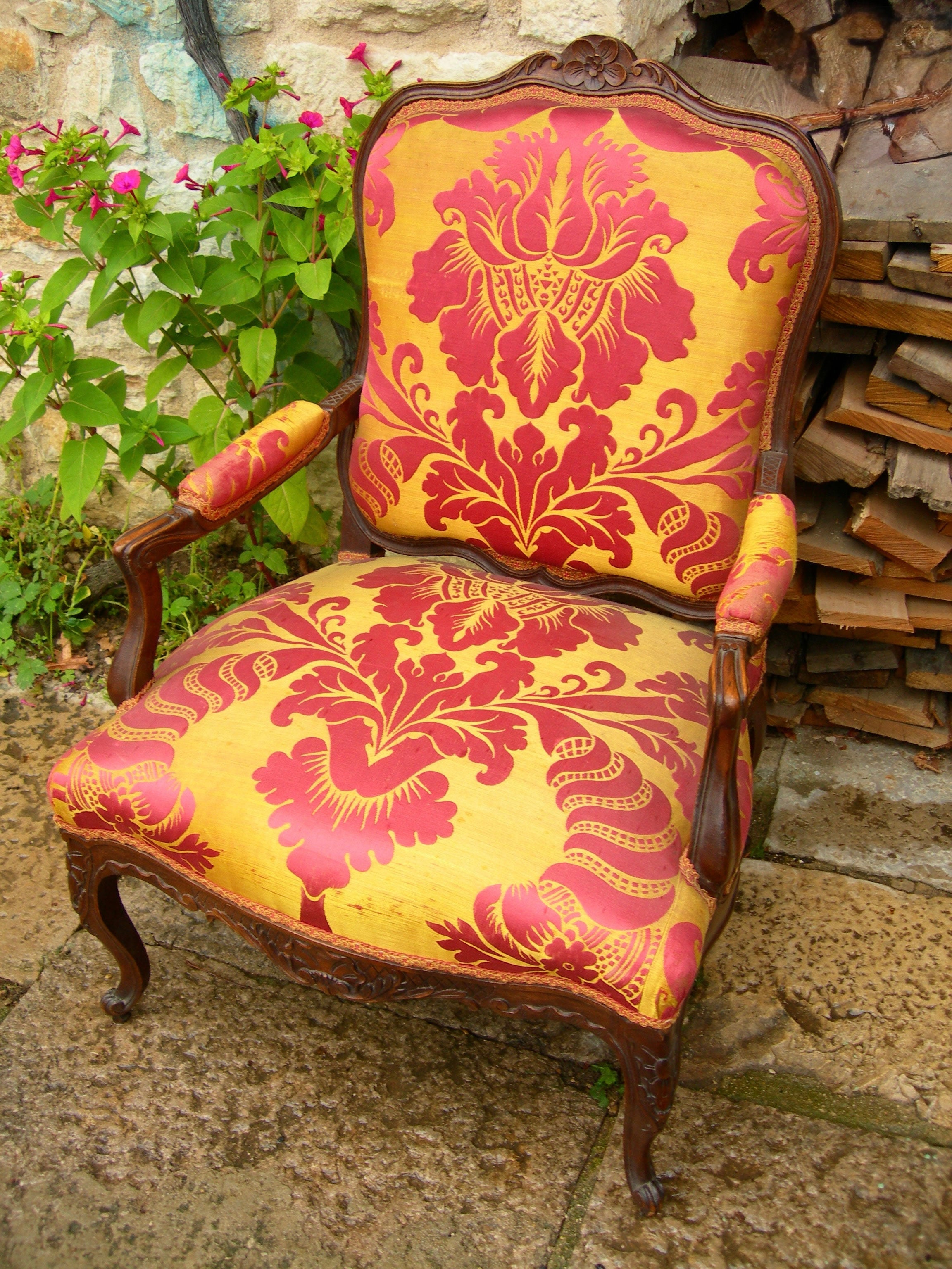 Antique French armchair with crimson and gold upholstery
